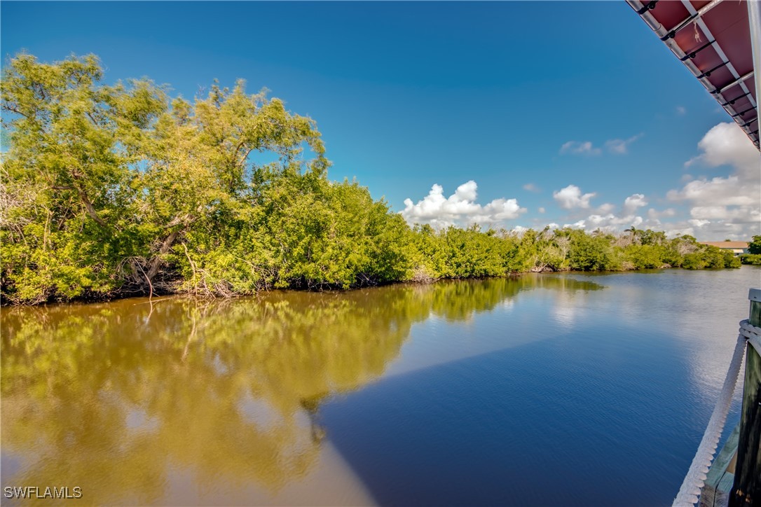 3083 Sloop Lane St. James City, FL 33956 - Photo 41 of 41 a view of a lake with a building in the background