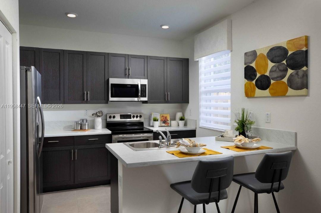 1070 Southeast 26th Street Homestead, FL 33035 - Photo 18 of 21 a kitchen with a sink and cabinets