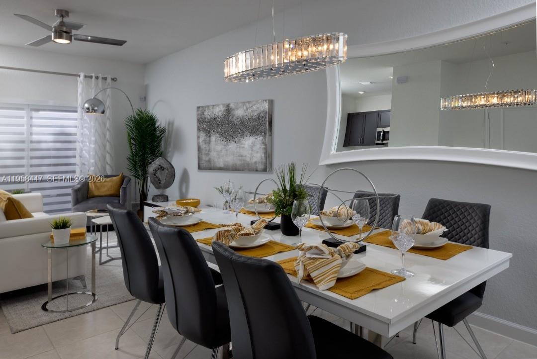 1070 Southeast 26th Street Homestead, FL 33035 - Photo 19 of 21 a view of a dining room with furniture and chandelier