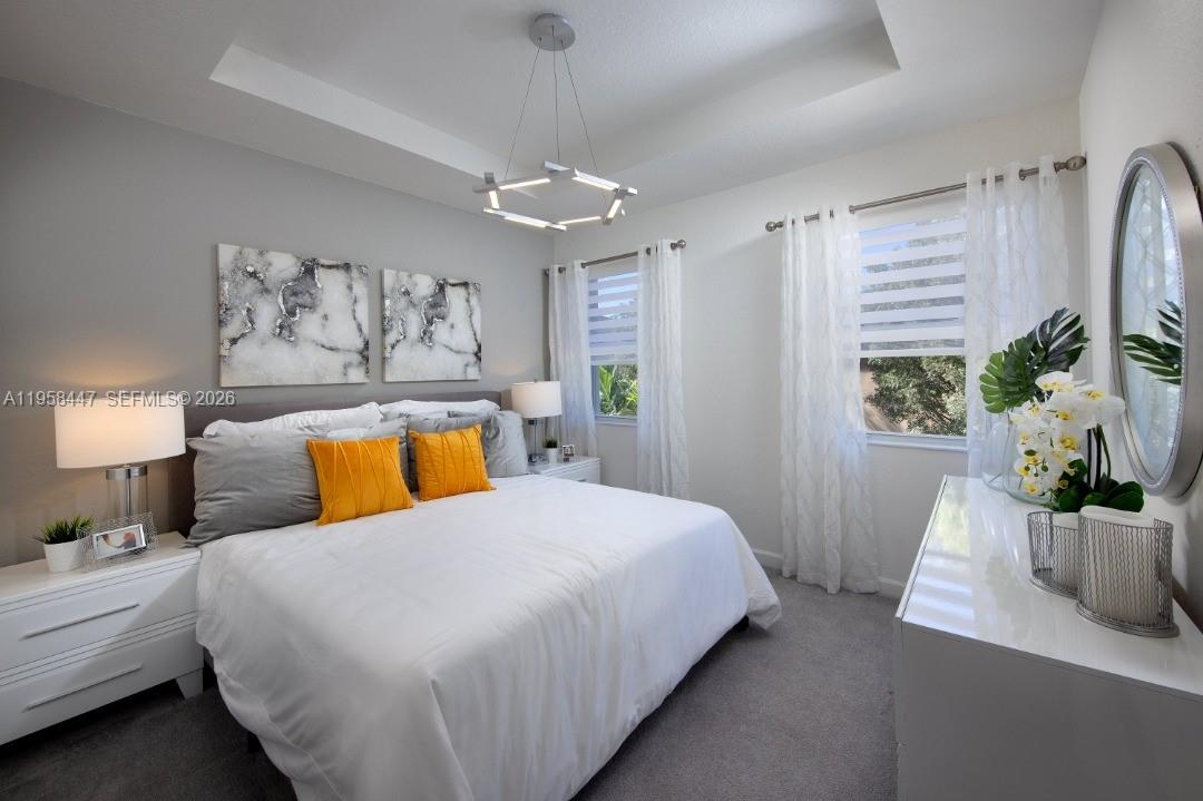 1070 Southeast 26th Street Homestead, FL 33035 - Photo 20 of 21 a bedroom with a large bed and a chandelier