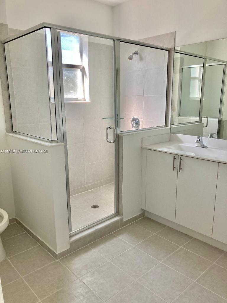 1070 Southeast 26th Street Homestead, FL 33035 - Photo 5 of 21 a bathroom with a shower sink and mirror