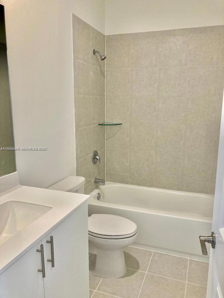 1070 Southeast 26th Street Homestead, FL 33035 - Photo 7 of 21 a bathroom with a sink a toilet and shower