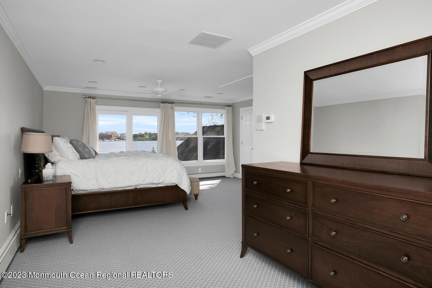 146 Conover Lane Red Bank, NJ 07701 - Photo 21 of 44 a bedroom with a bed and a large mirror on dresser