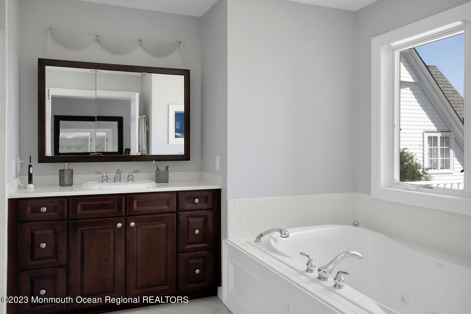 146 Conover Lane Red Bank, NJ 07701 - Photo 22 of 44 a bathroom with a tub a double vanity sink and mirror with window