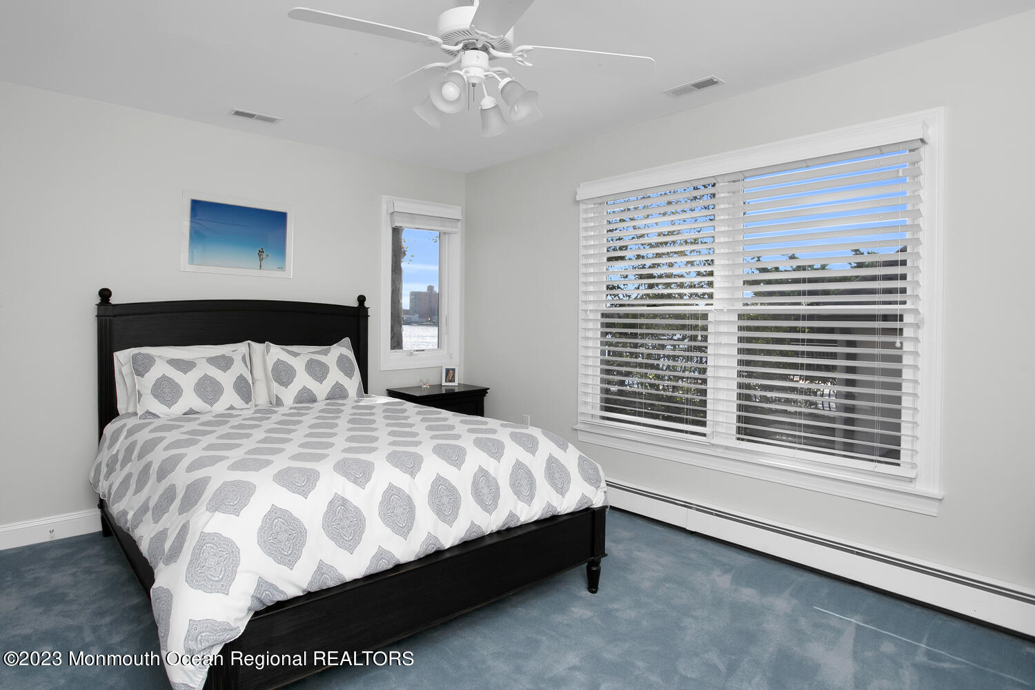 146 Conover Lane Red Bank, NJ 07701 - Photo 26 of 44 a bedroom with a large bed and a chandelier