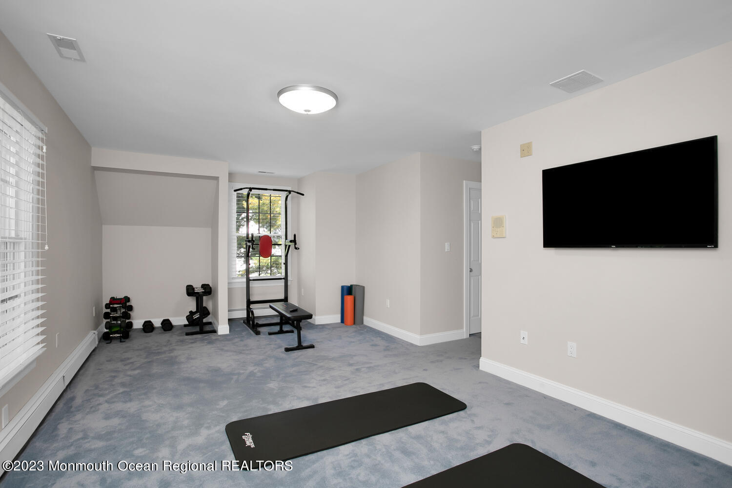 146 Conover Lane Red Bank, NJ 07701 - Photo 31 of 44 a room with gym equipment and a flat screen tv