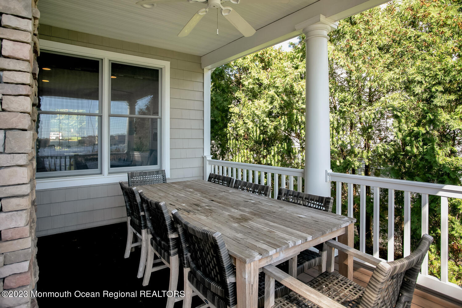 146 Conover Lane Red Bank, NJ 07701 - Photo 34 of 44 a view of a deck with table and chairs with wooden floor and fence