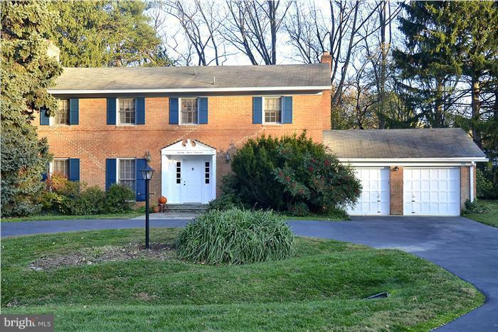 7700 Groton Road Bethesda, MD 20817 - Photo 1 of 30 a front view of a house with a yard and garage