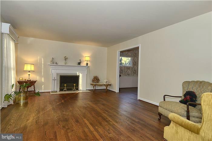 7700 Groton Road Bethesda, MD 20817 - Photo 2 of 30 a view of livingroom with furniture and a fireplace