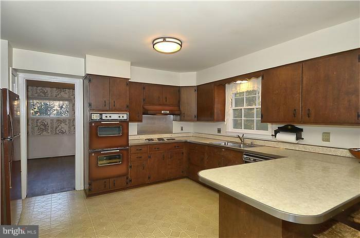 7700 Groton Road Bethesda, MD 20817 - Photo 12 of 30 a kitchen with stainless steel appliances granite countertop a sink stove and refrigerator
