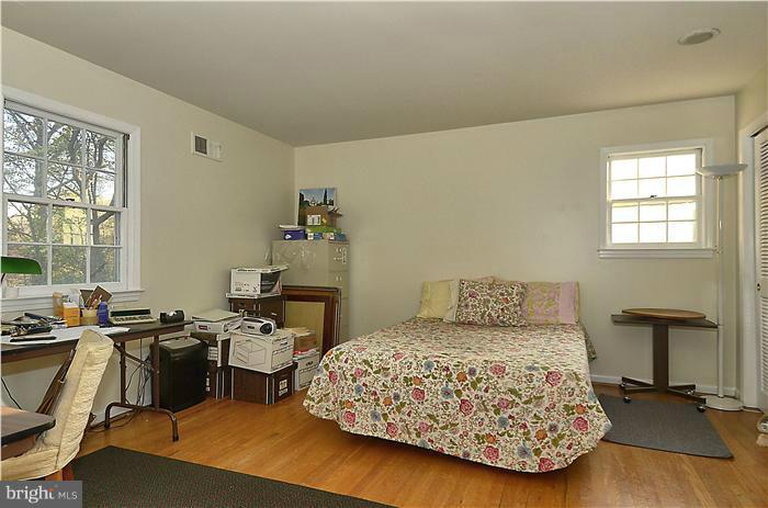 7700 Groton Road Bethesda, MD 20817 - Photo 20 of 30 a bedroom with a bed and wooden floor