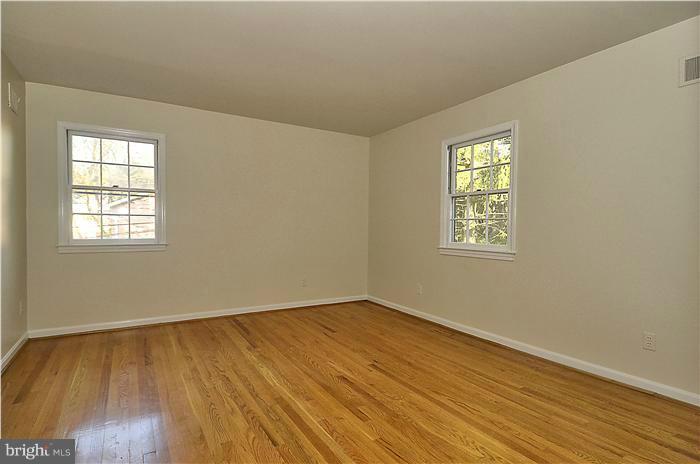 7700 Groton Road Bethesda, MD 20817 - Photo 21 of 30 a view of an empty room with wooden floor and a window
