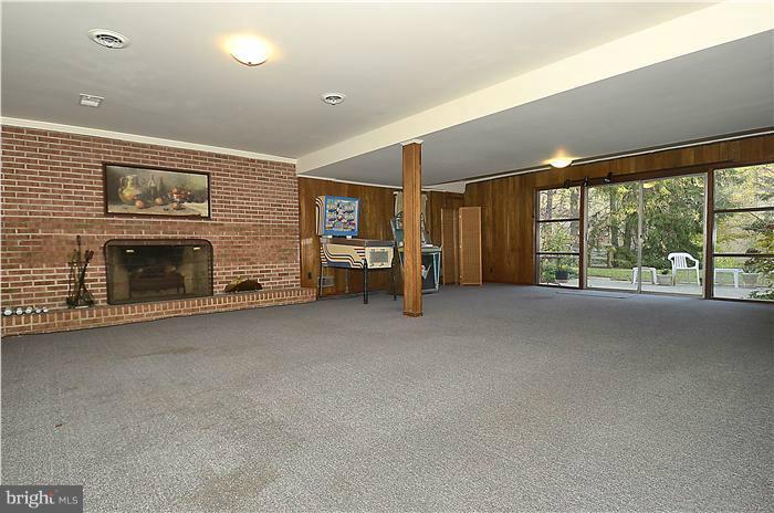 7700 Groton Road Bethesda, MD 20817 - Photo 22 of 30 a view of an empty room with fireplace and a window