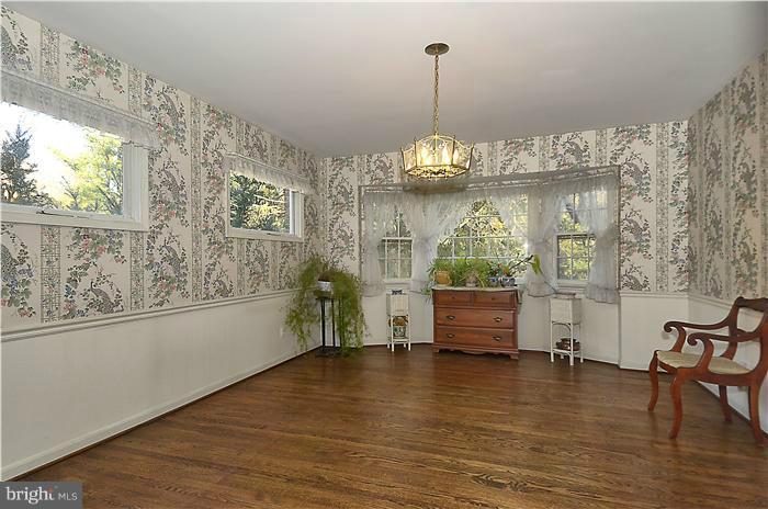 7700 Groton Road Bethesda, MD 20817 - Photo 6 of 30 a view of dining room and livingroom with furniture wooden floor a chandelier