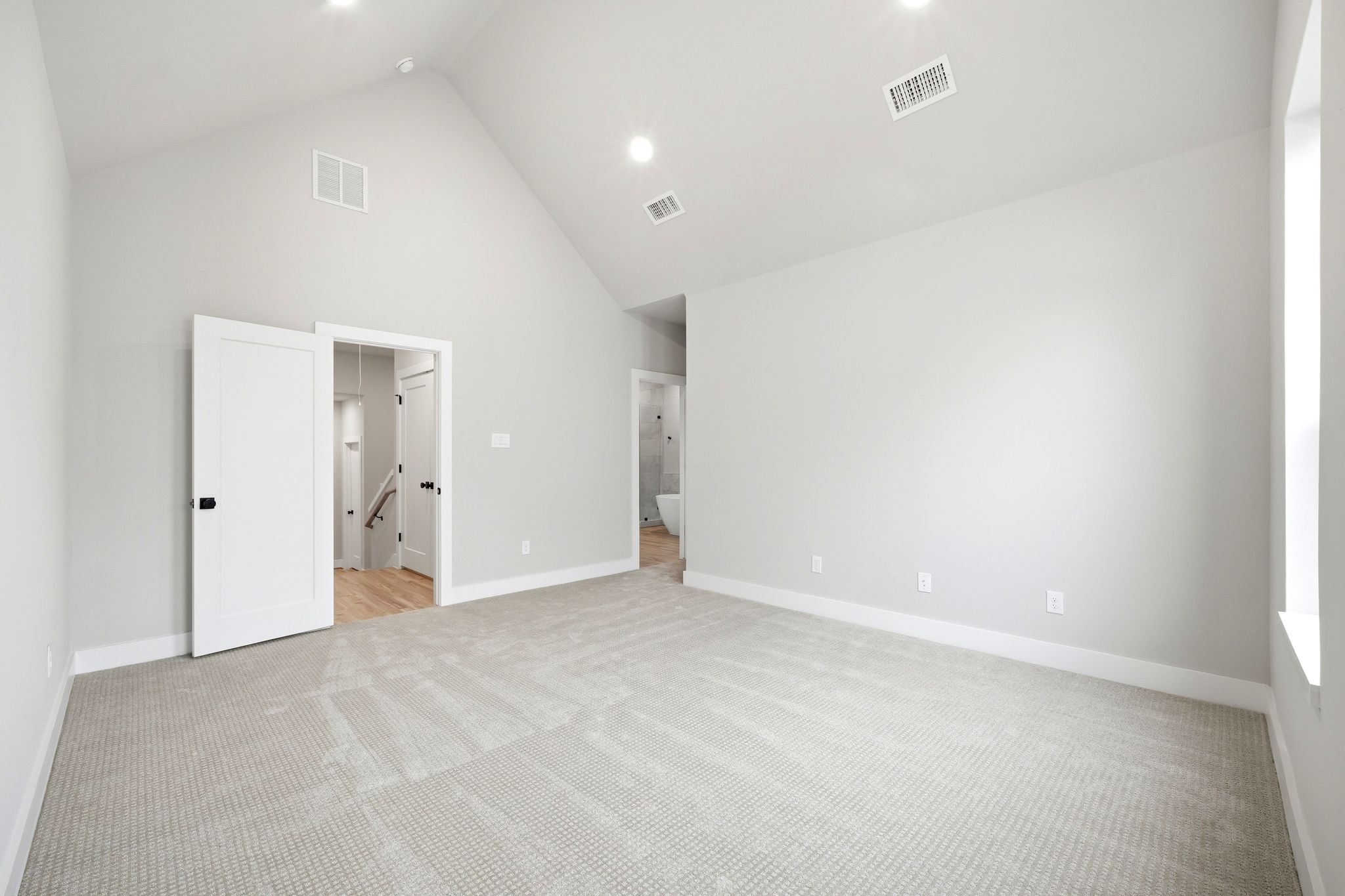5814 Cebra Street Houston, TX 77091 - Photo 19 of 32 Expansive primary suite combining vaulted ceilings, natural light, and functional layout.