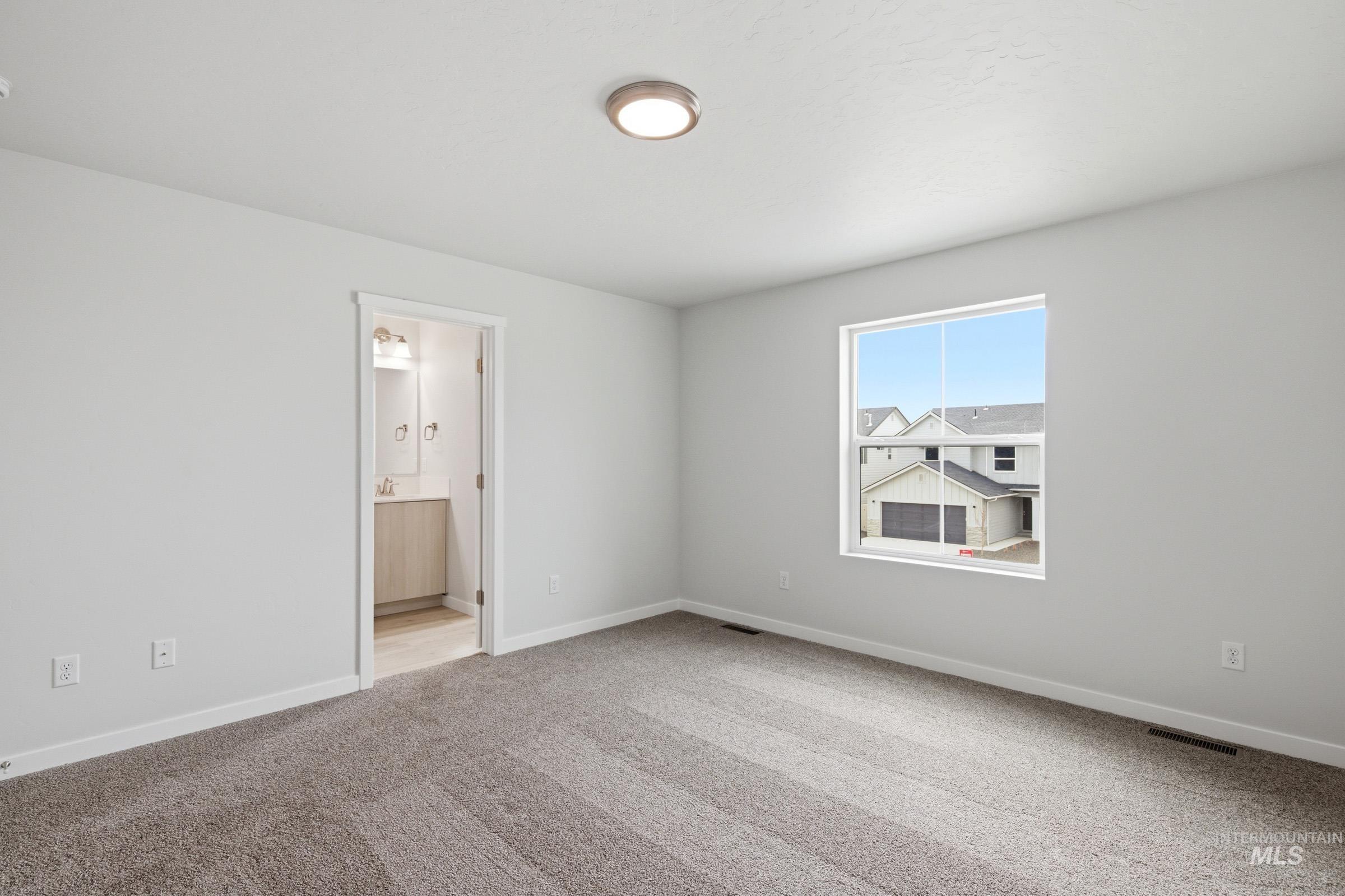 10770 Rutland Street Caldwell, ID 83605 - Photo 18 of 22 Carpeted room featuring a single window, a flush-mount ceiling light, and light gray wall paint