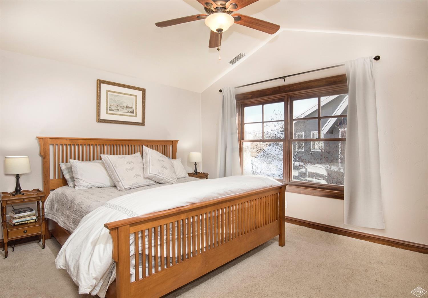 83 Newquist Street Eagle, CO 81631 - Photo 20 of 25 a bedroom with a large bed and a large window