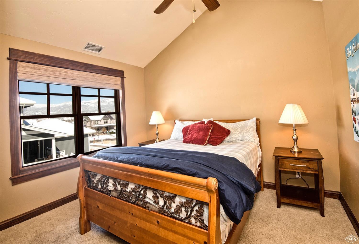 83 Newquist Street Eagle, CO 81631 - Photo 21 of 25 a bed sitting in a bedroom next to a window