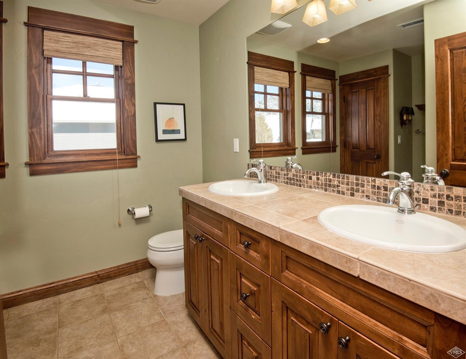 83 Newquist Street Eagle, CO 81631 - Photo 22 of 25 a bathroom with a double vanity sink toilet and a mirror