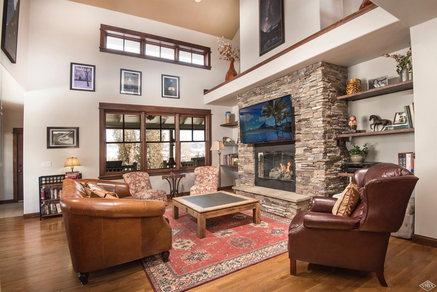 83 Newquist Street Eagle, CO 81631 - Photo 3 of 25 a living room with furniture wooden floor and a fireplace