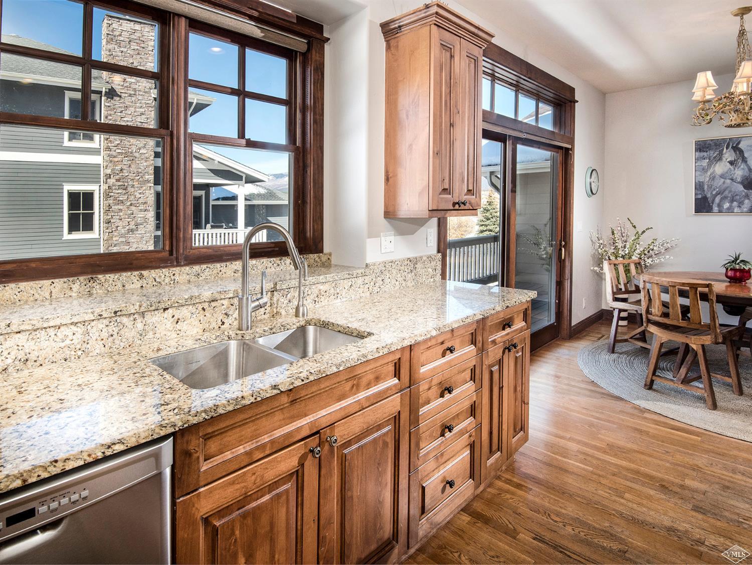 83 Newquist Street Eagle, CO 81631 - Photo 8 of 25 a kitchen with stainless steel appliances granite countertop a sink stove and wooden floor