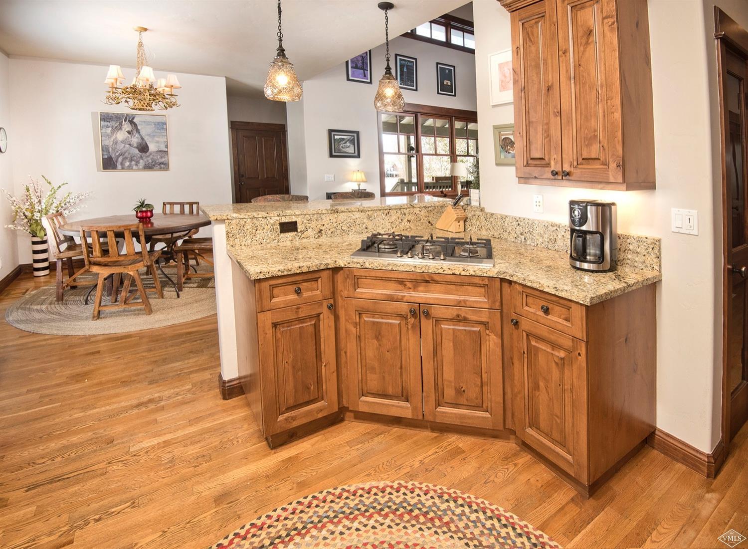 83 Newquist Street Eagle, CO 81631 - Photo 9 of 25 a view of a kitchen with granite countertop a sink stainless steel appliances and cabinets