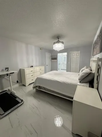 a bedroom with bed and window