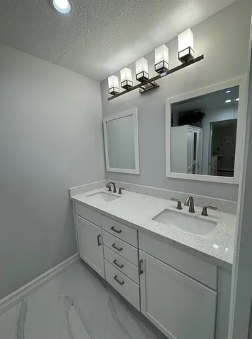 a bathroom with a double vanity sink and mirror