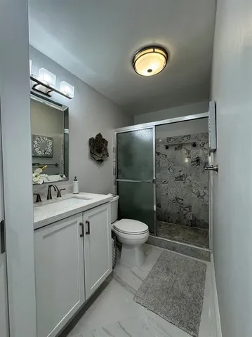 a bathroom with a sink toilet and shower