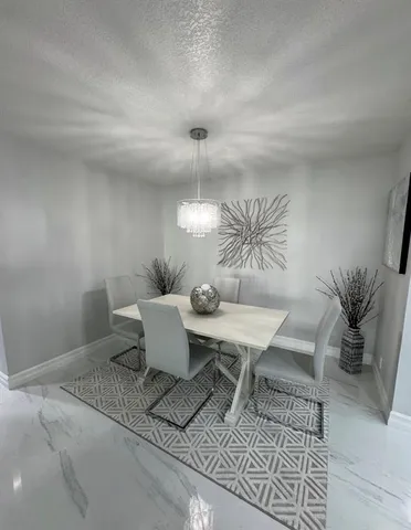 a dining room with a table and chairs