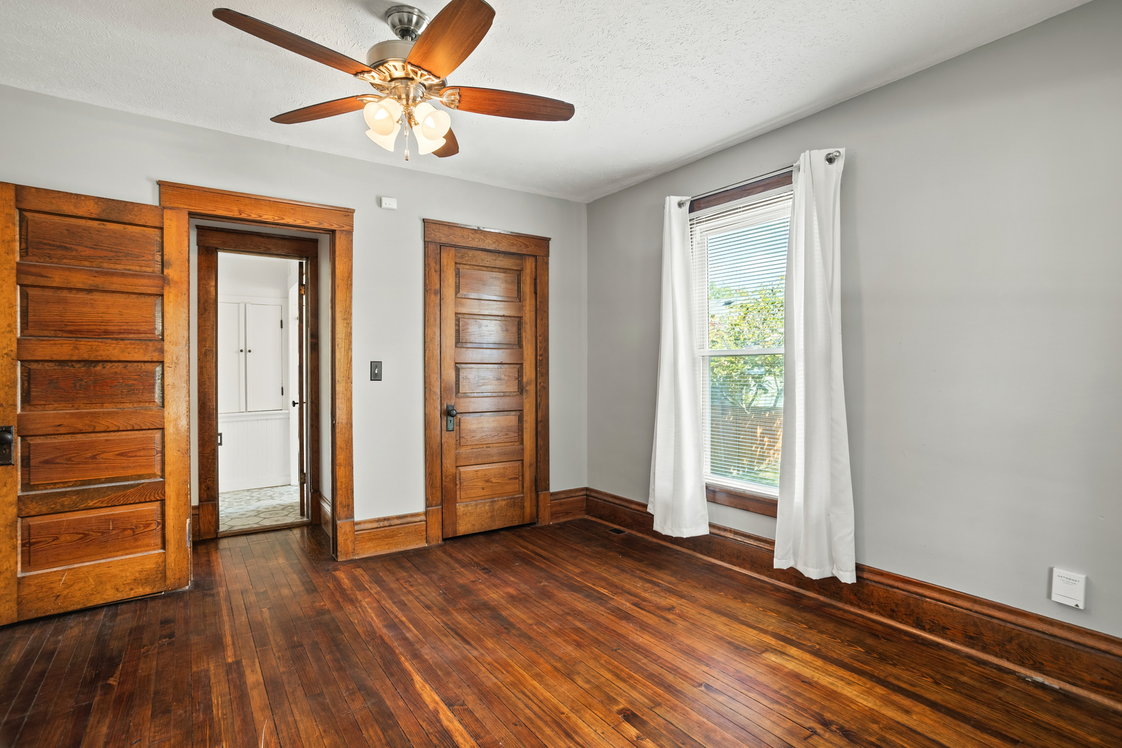 702 North Walnut Street Normal, IL 61761 - Photo 11 of 45 wooden floor in an empty room with a window