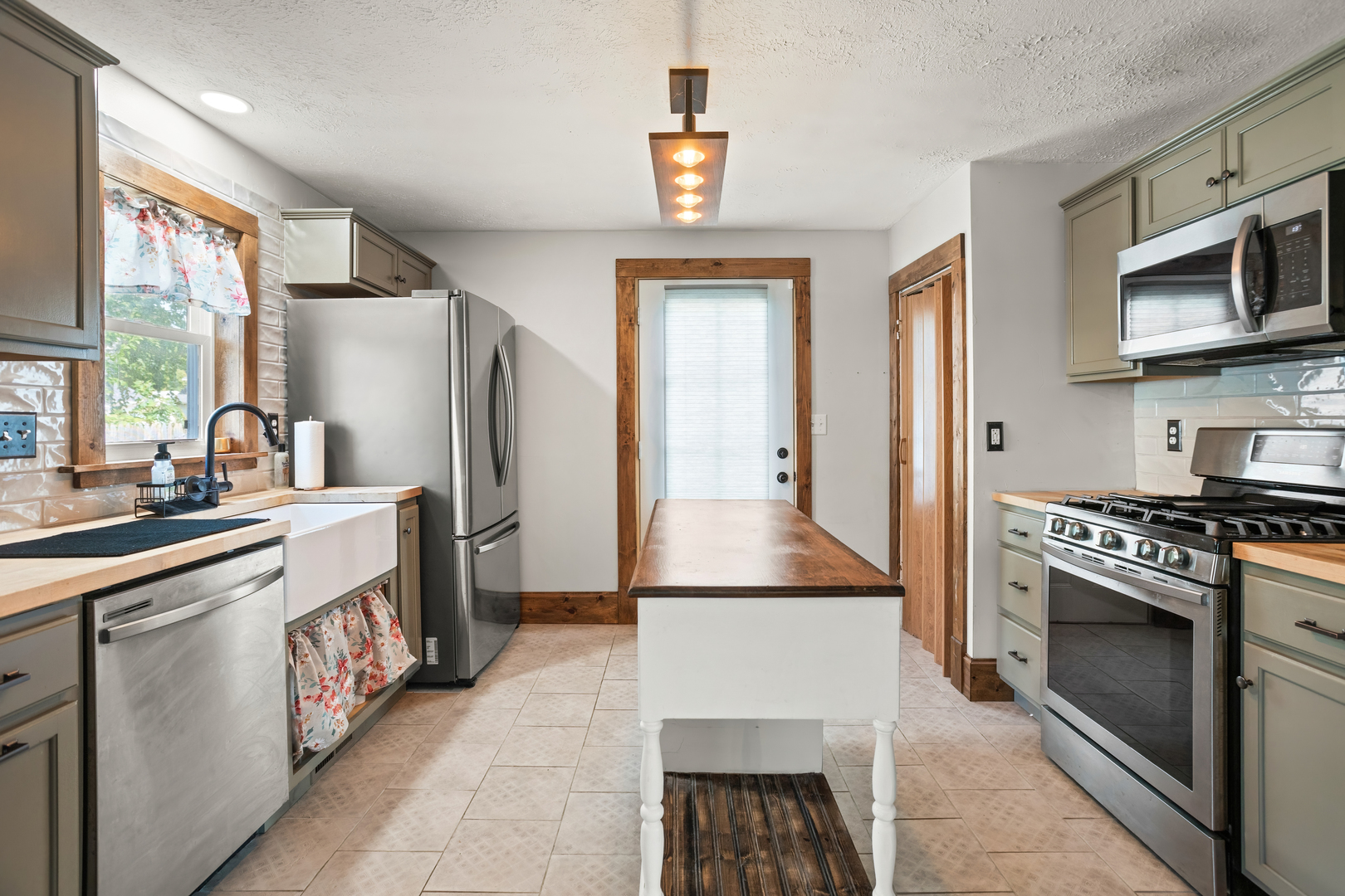 702 North Walnut Street Normal, IL 61761 - Photo 16 of 45 a kitchen with stainless steel appliances granite countertop a refrigerator a stove a sink and a microwave