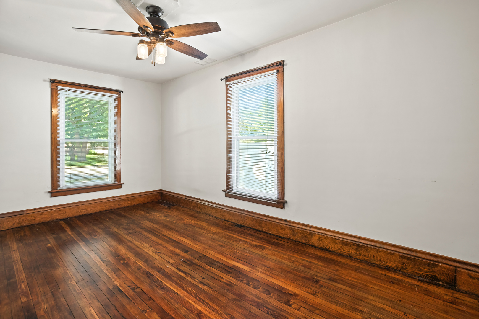 702 North Walnut Street Normal, IL 61761 - Photo 18 of 45 a view of empty room with wooden floor and fan