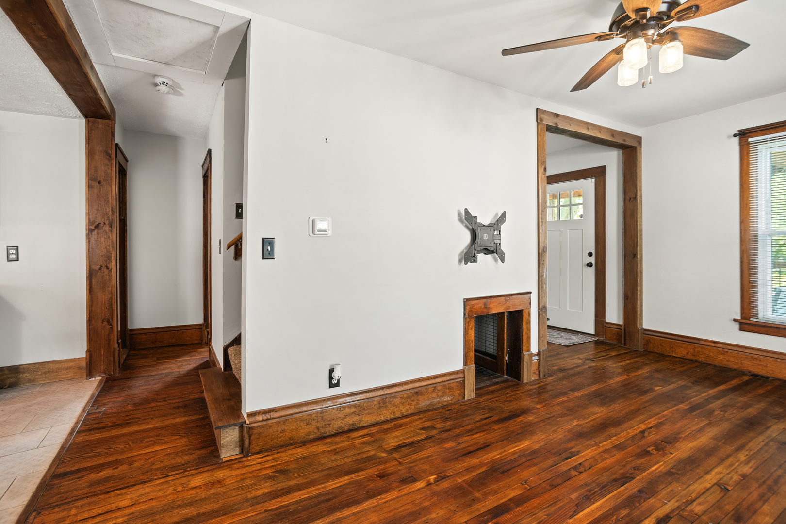 702 North Walnut Street Normal, IL 61761 - Photo 19 of 45 a view of an empty room with wooden floor and a ceiling fan
