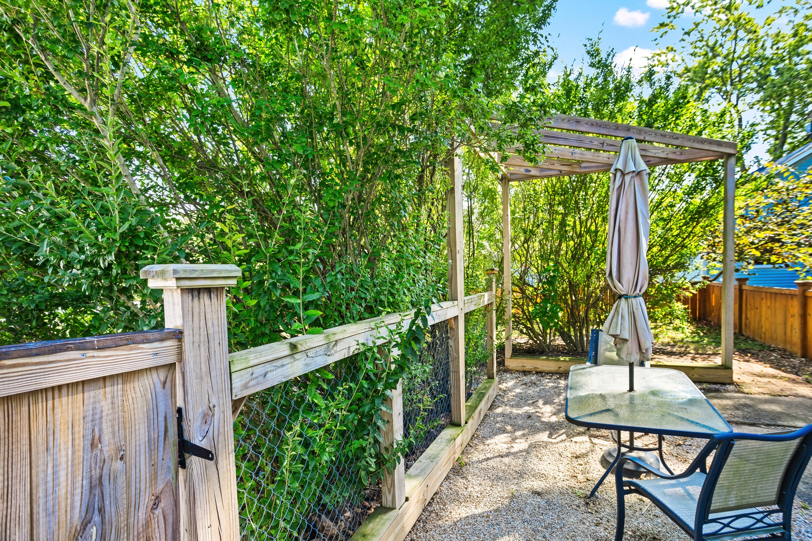 702 North Walnut Street Normal, IL 61761 - Photo 33 of 45 a view of a patio with table and chairs with wooden fence and plants