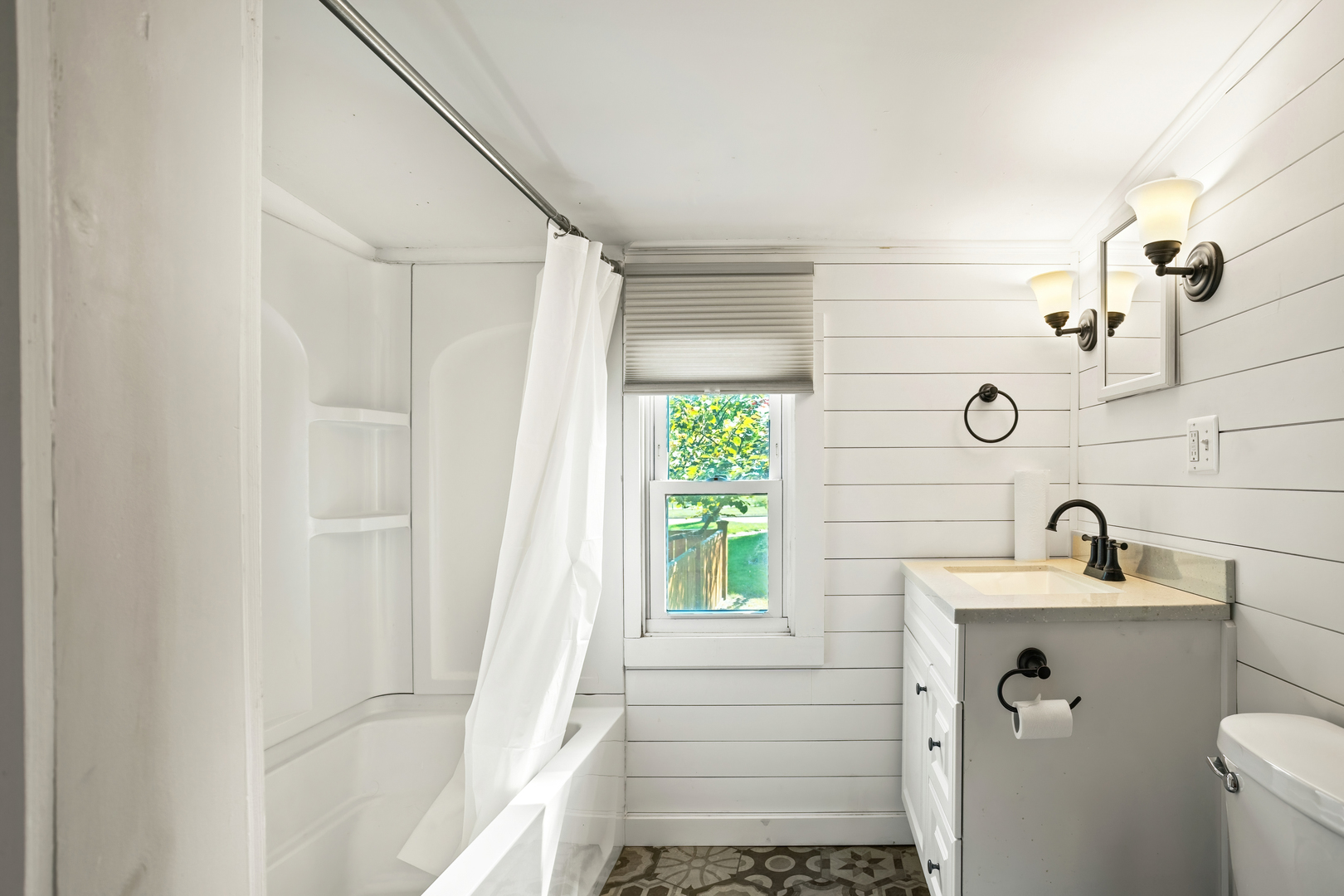 702 North Walnut Street Normal, IL 61761 - Photo 4 of 45 a bathroom with a sink a toilet and shower