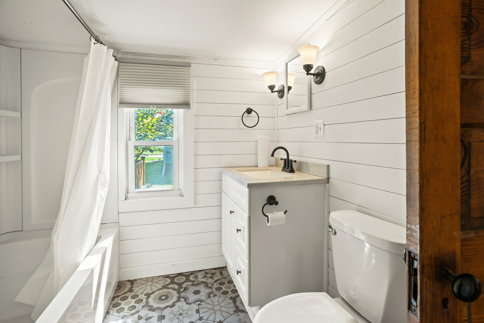 702 North Walnut Street Normal, IL 61761 - Photo 6 of 45 a bathroom with a sink a toilet and shower curtain