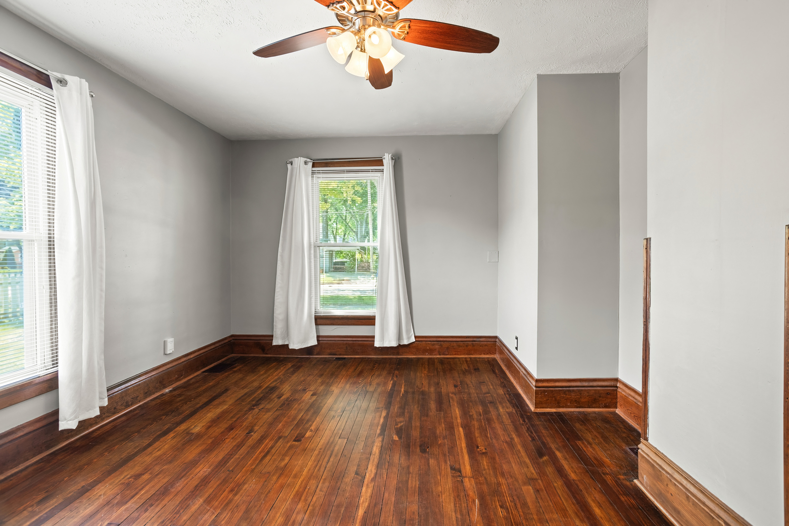 702 North Walnut Street Normal, IL 61761 - Photo 8 of 45 a view of empty room with wooden floor and fan