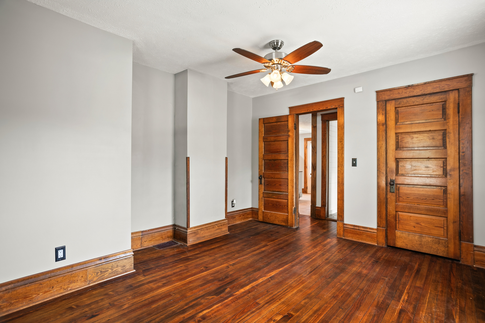 702 North Walnut Street Normal, IL 61761 - Photo 10 of 45 an empty room with wooden floor closet and windows