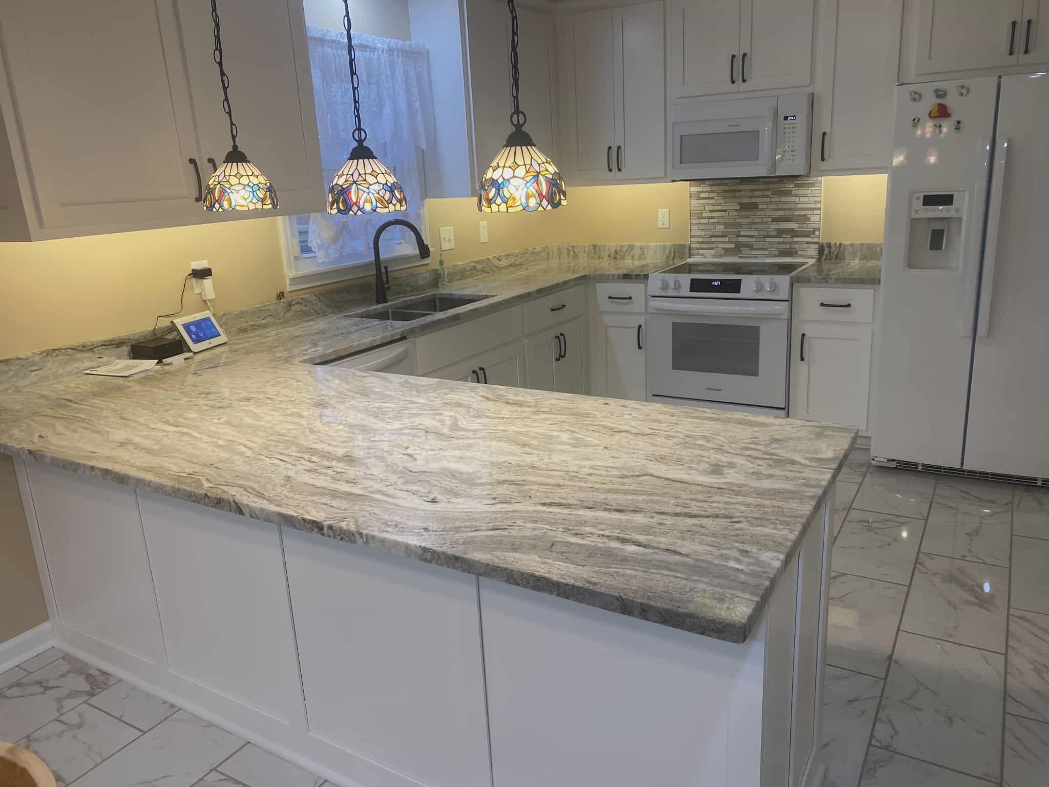 175 Austin Street Savannah, TN 38372 - Photo 5 of 33 a kitchen with granite countertop a sink stainless steel appliances a counter top space and cabinets