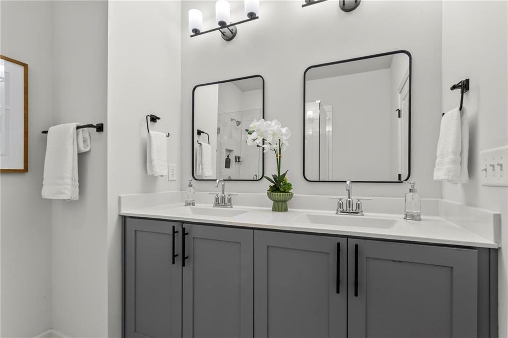 718 Needletail Way Atlanta, GA 30312 - Photo 23 of 44 a bathroom with double vanity sinks and a mirror