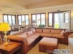 a living room with furniture and large windows