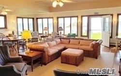 15 Downs Boulevard Jamesport, NY 11970 - Photo 18 of 25 a living room with furniture and large windows