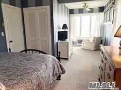 15 Downs Boulevard Jamesport, NY 11970 - Photo 20 of 25 a bedroom with a bed and a couch