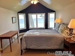 15 Downs Boulevard Jamesport, NY 11970 - Photo 22 of 25 a bedroom with a bed and a window