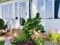 a view of swimming pool with a yard and large trees
