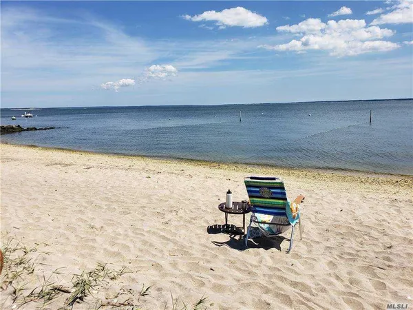 a view of a lake with a table and chairs