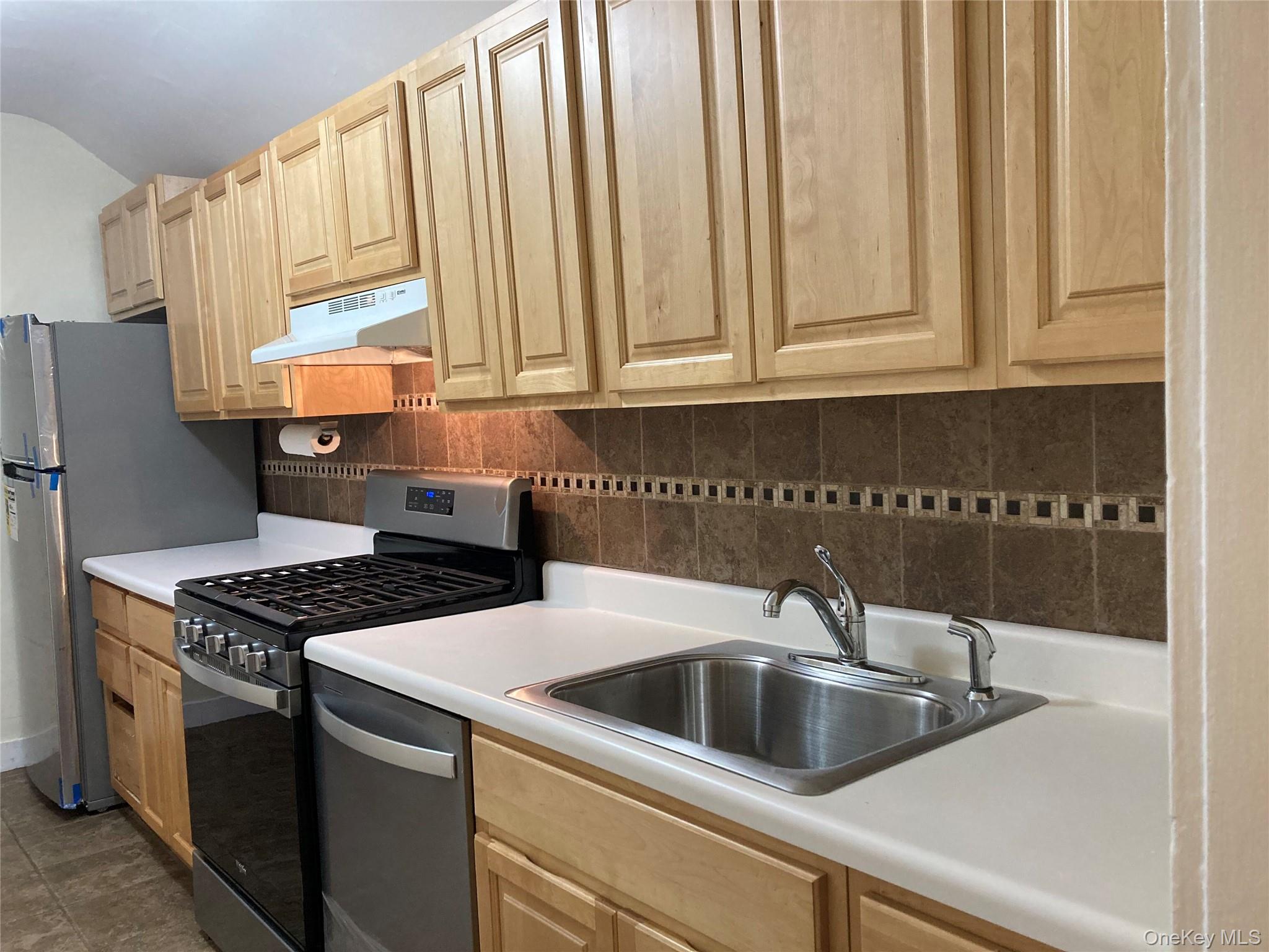 51 Parkway Road, Unit 3 Bronxville, NY 10708 - Photo 19 of 20 a kitchen with granite countertop a sink a stove and cabinets
