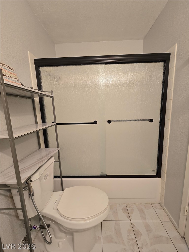 6750 Del Rey Avenue, Unit 133 Las Vegas, NV 89146 - Photo 27 of 34 The bathroom features a sleek, modern shower enclosure and tiled flooring.
