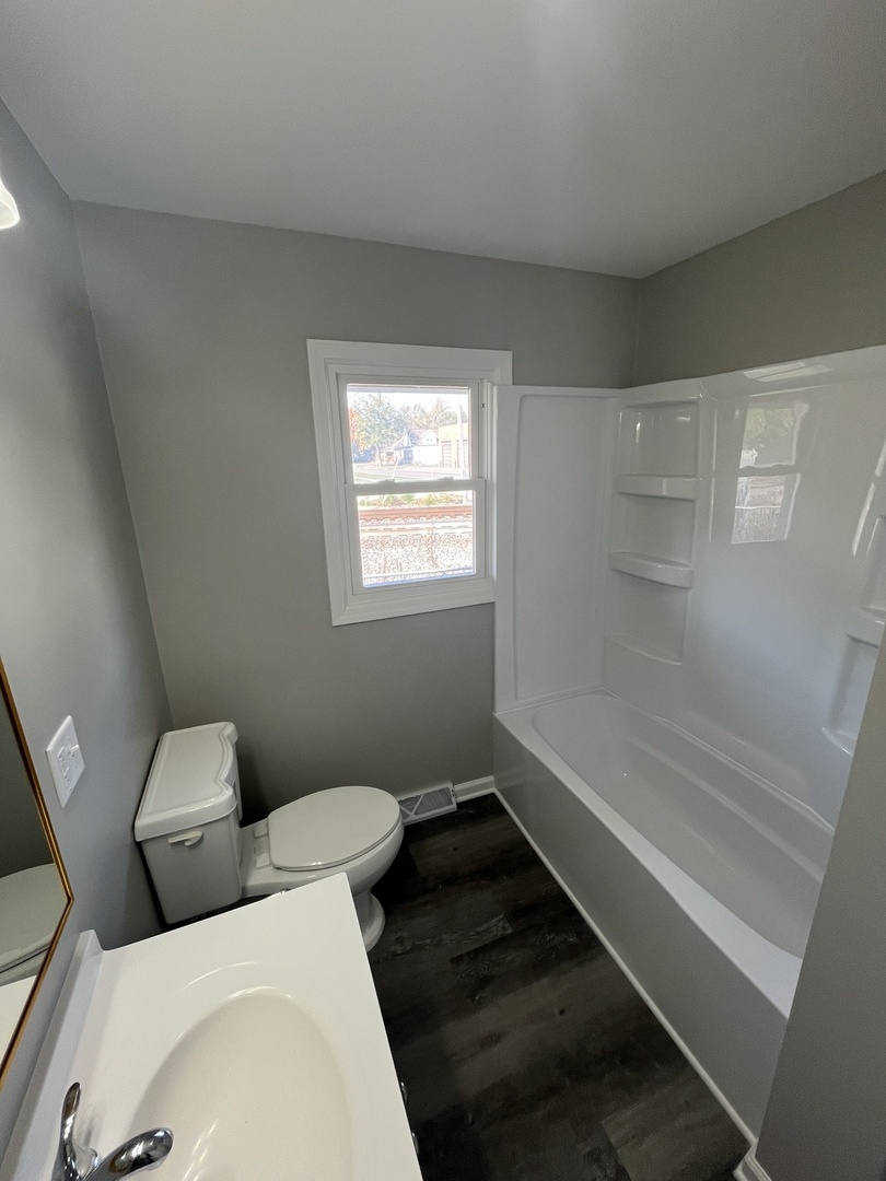 701 Lundy Street Streator, IL 61364 - Photo 11 of 21 a bathroom with a toilet and a shower